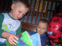 Tommy reads to Nicholas.