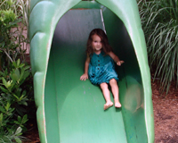 Sliding down a pea pod in the Children's Garden.
